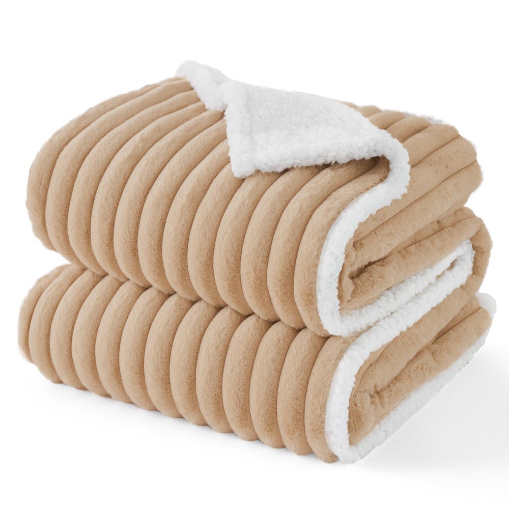 Bedsure ComfyFleece waterproof dog blanket on sofa protects furniture from spills and fur.
