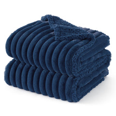 Bedsure ComfyFleece waterproof dog blanket on navy couch protects furniture