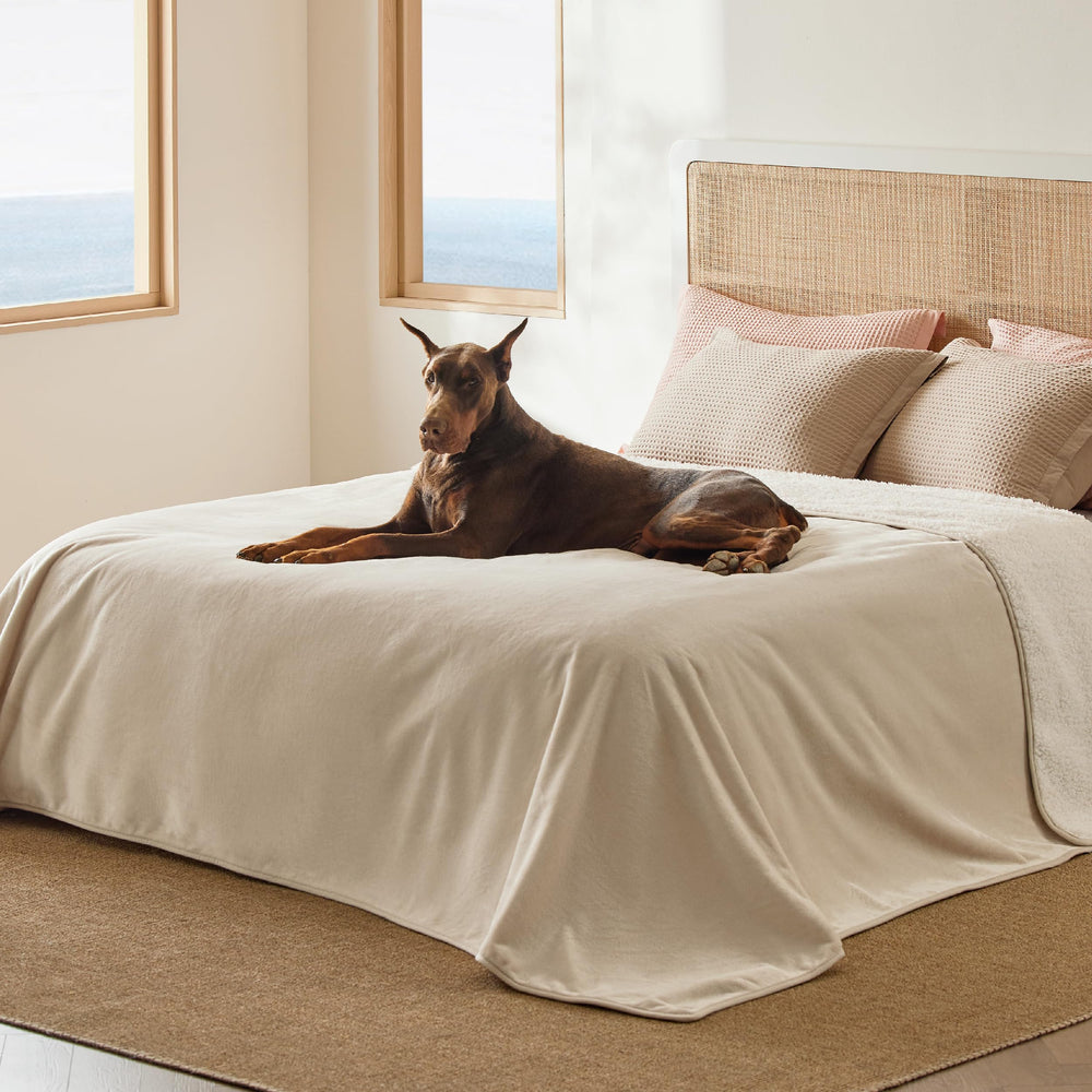 Bedsure waterproof blanket on bed in cream protects surfaces from moisture