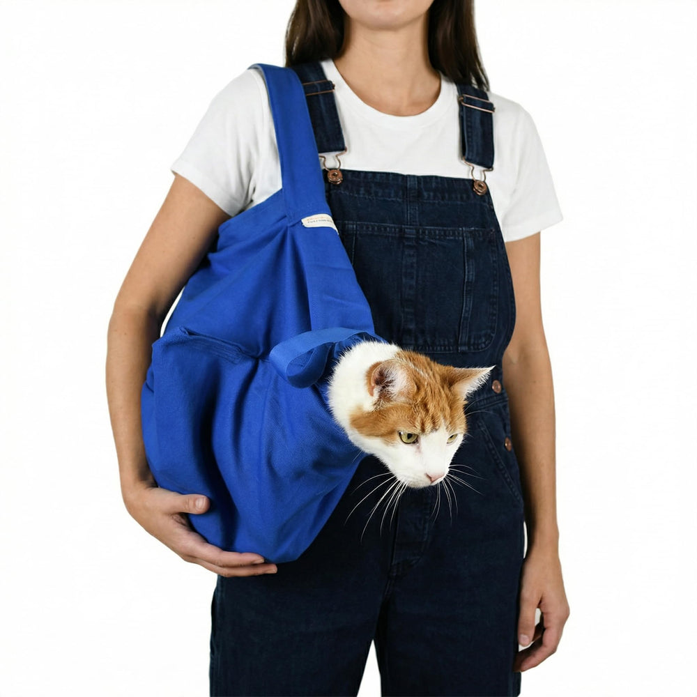 Cat-in-the-Bag Cozy Comfort Carrier in cobalt blue, front view showing roomy interior for cats.