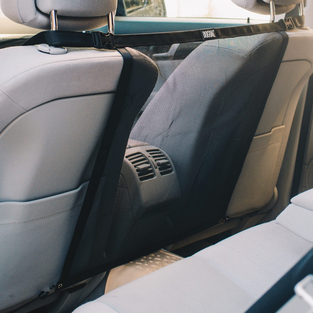 DOGUAL car net barrier showing universal fit behind the back seat for safety.