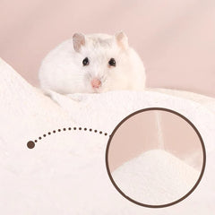 Sand being dispensed into a hamster bath area for play