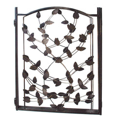 Etna Leaf Design pet gate folded flat for compact storage behind a couch.