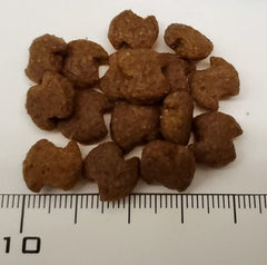 Eukanuba Senior Small Breed kibble close-up highlighting dental health via tartar reduction.