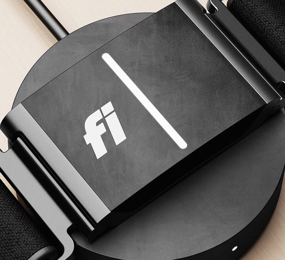 Fi Series 3 charging base indoors beside a Wi-Fi router for reliable connectivity.