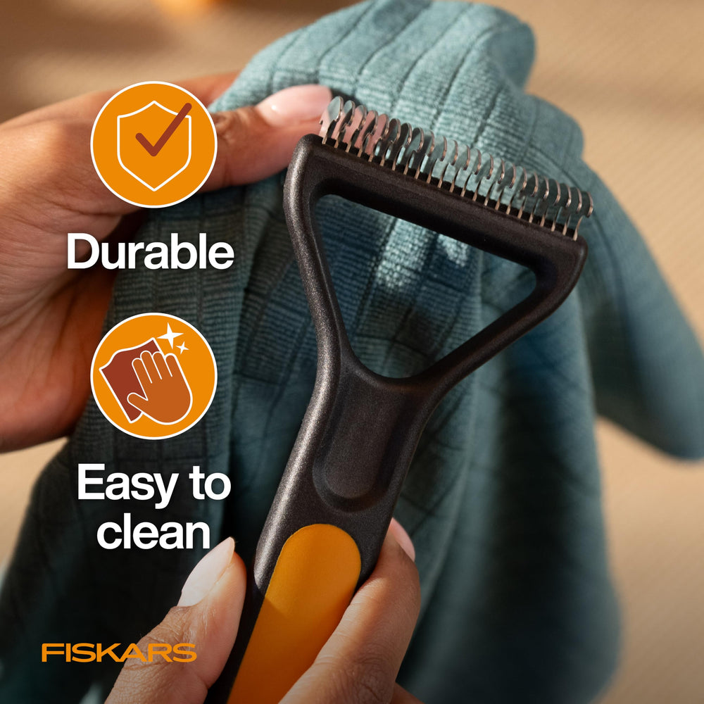 Fiskars rake shown on long fur with easy-clean design.
