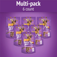 Friskies Party Mix Crunch treats close-up reveals turkey and gravy flavors for tempting rewards.