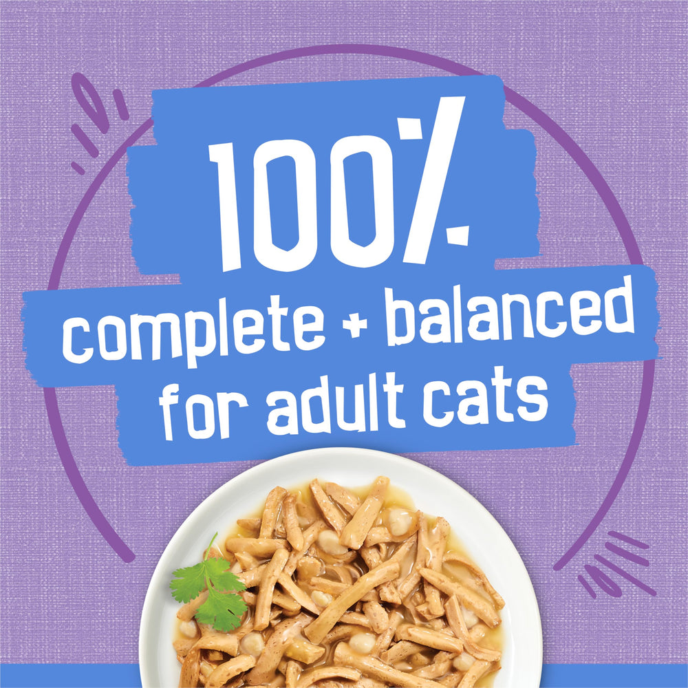 Friskies Shreds Turkey Dinner in Gravy served in a bowl, a cat enjoying a meal.