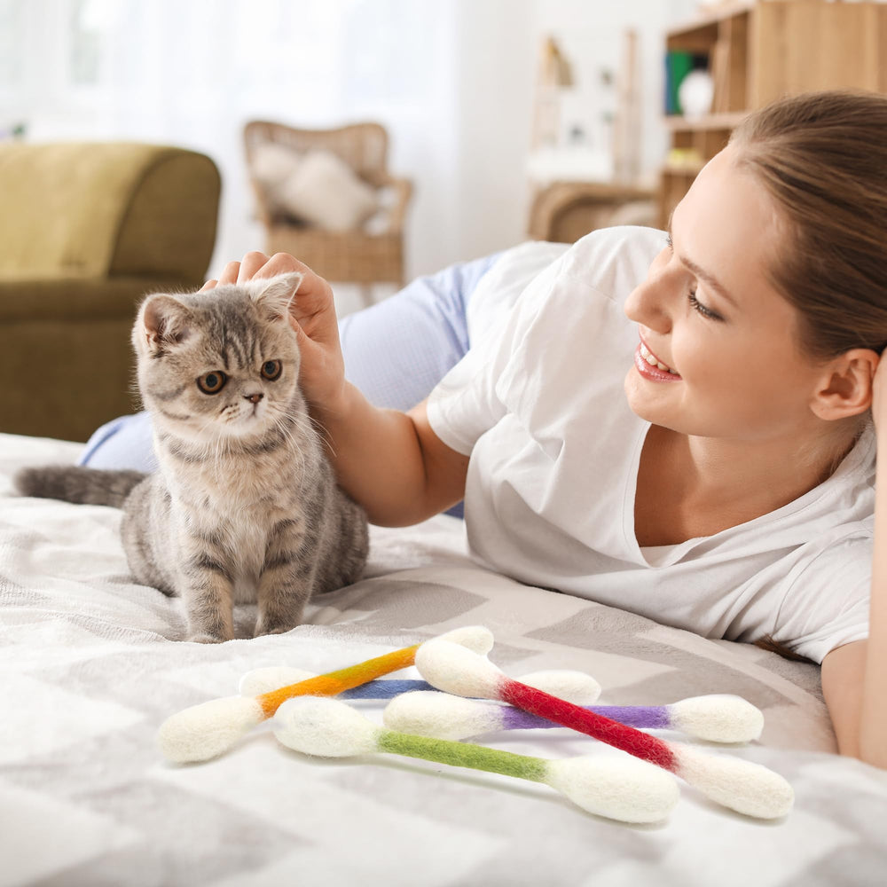 Glaciart One swabs cat toys catnip, cat enjoying interactive chase and nibbling fun.