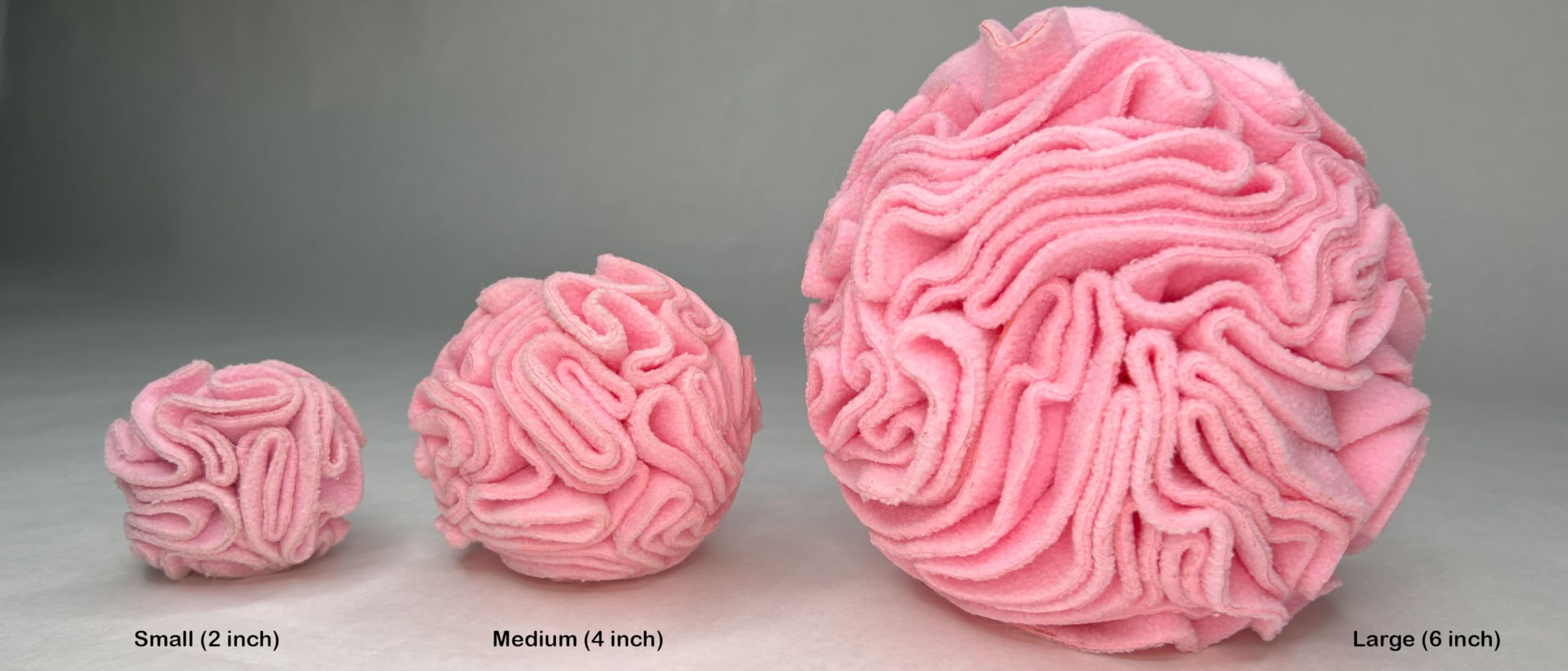 Glory To Dog snuffleball pink being tossed for interactive enrichment and problem solving