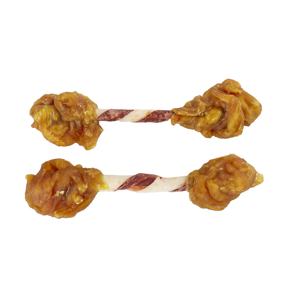 GOOD 'N' FUN Triple Flavor Double Pops with Chicken dog enjoying outdoors while chewing.