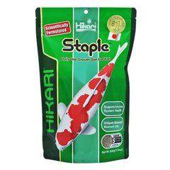 Hikari Staple Pellets floating large 22-lb in aquarium supports monitoring consumption and water quality.
