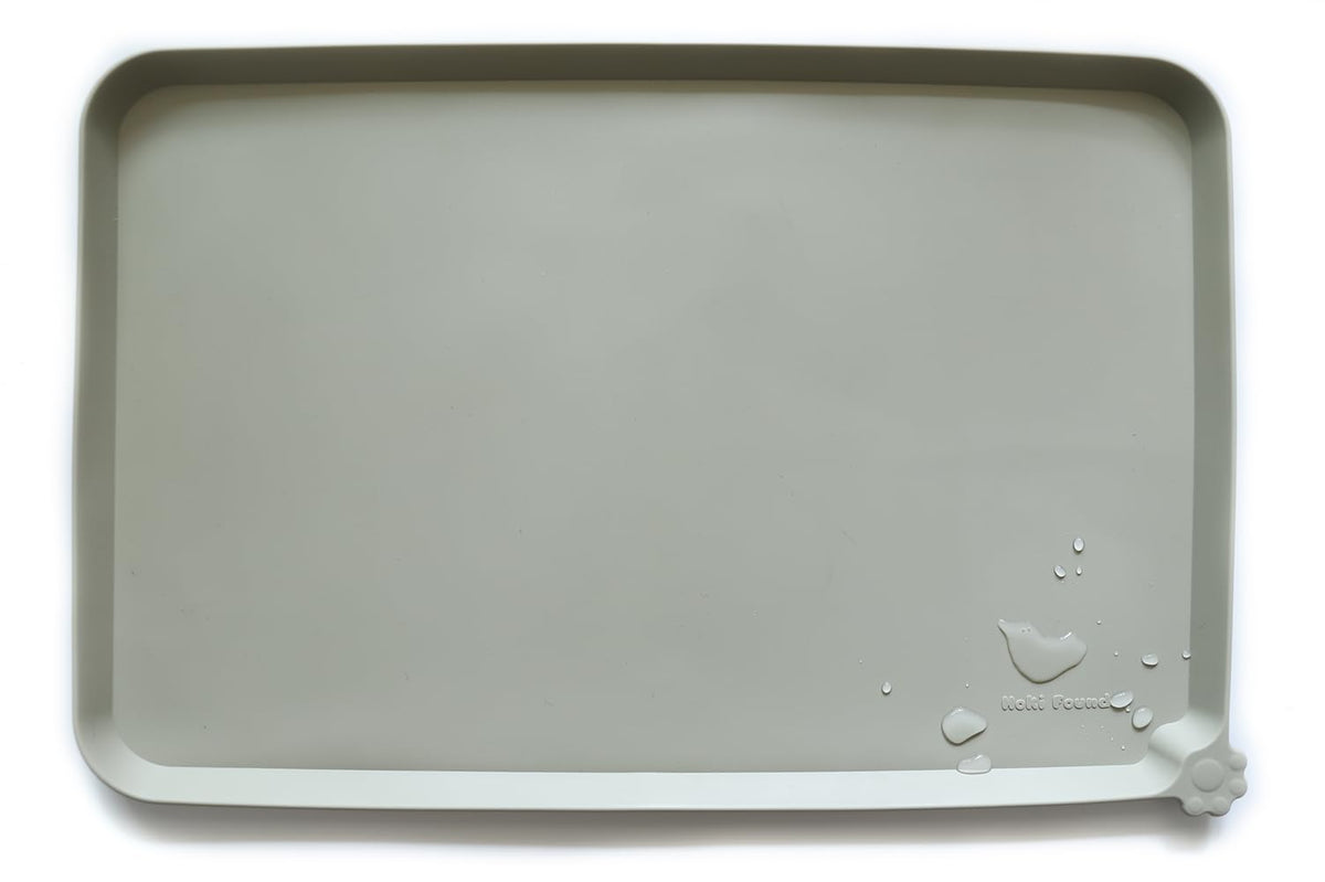 Hoki Found L silicone non-slip pet bowl mat in cream green keeps bowls steady on carpets.