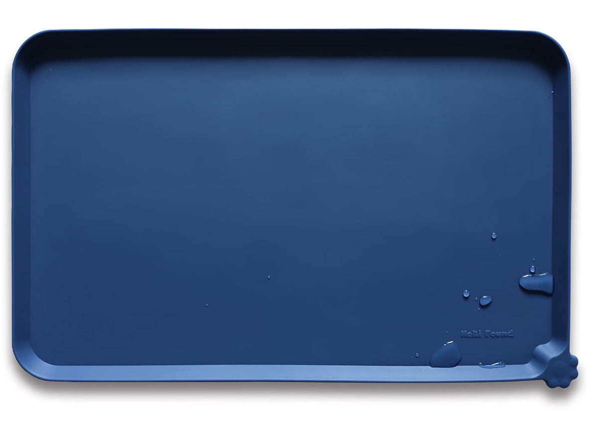 Hoki Found L silicone pet food mat in indigo protects floors from spills.