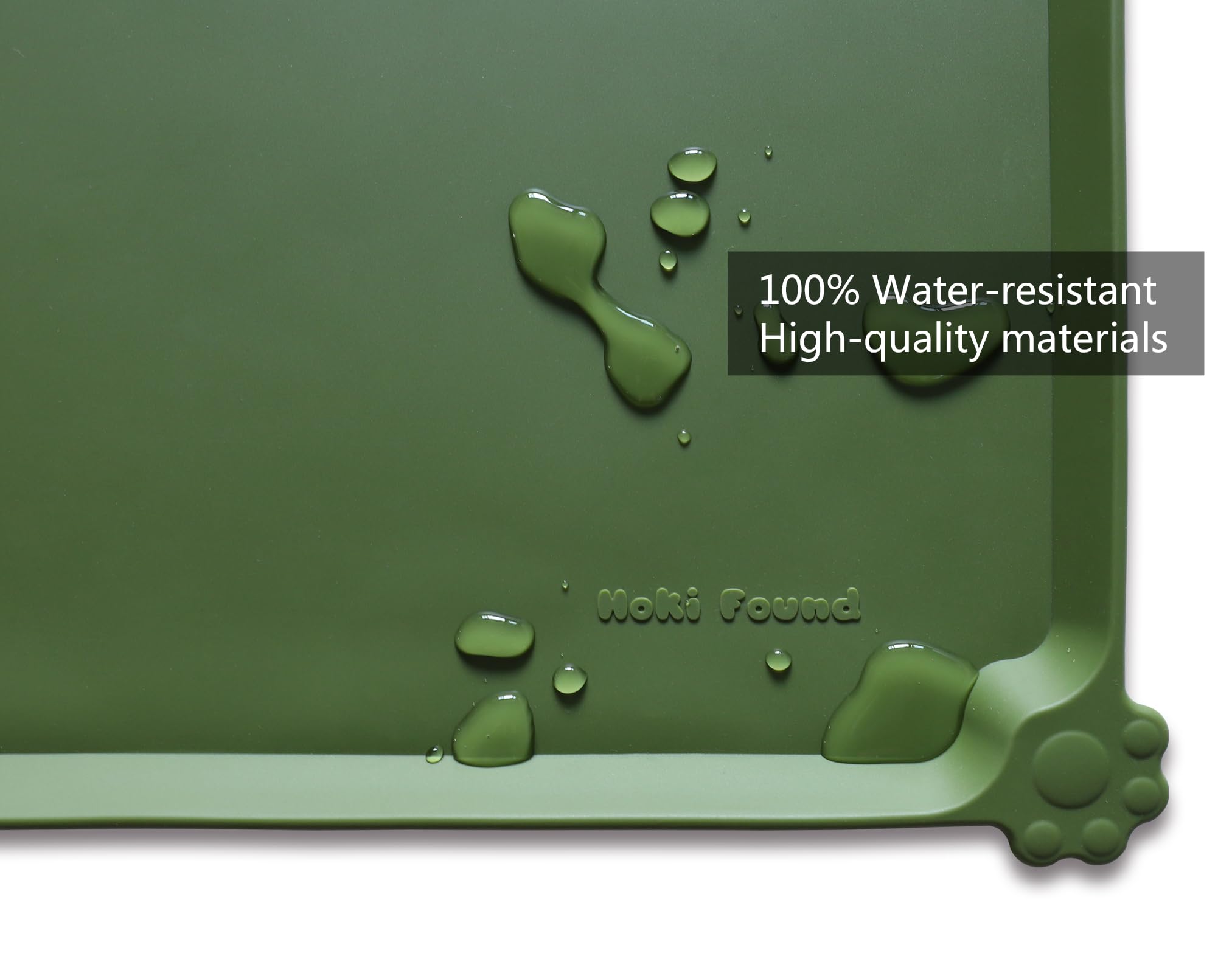 Hoki Found raised-edge silicone feeding mat prevents spills on floors.