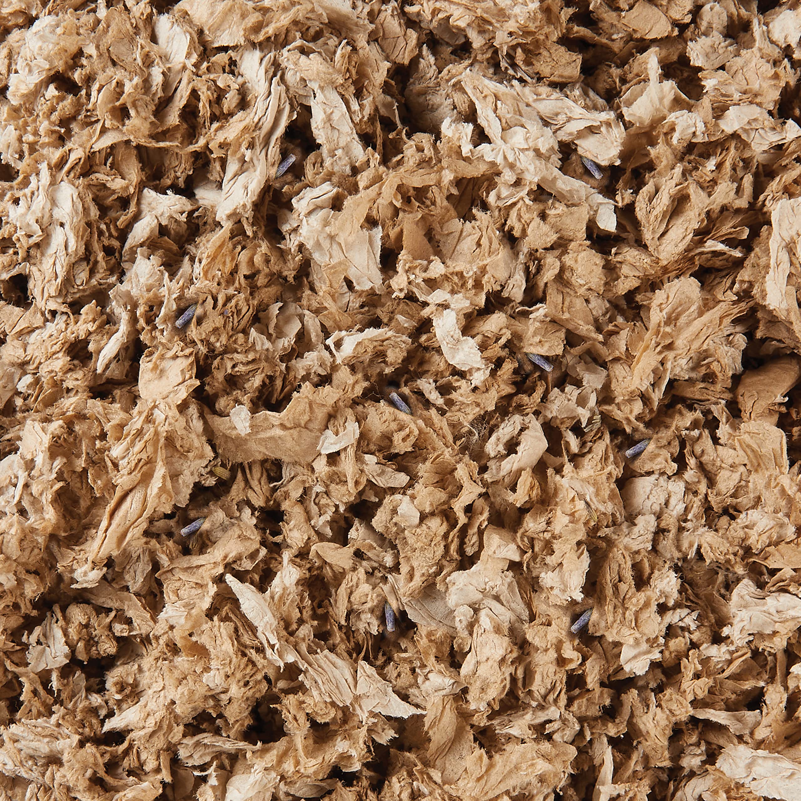 Kaytee bedding close-up shows absorption capability and soft texture for cozy nesting.