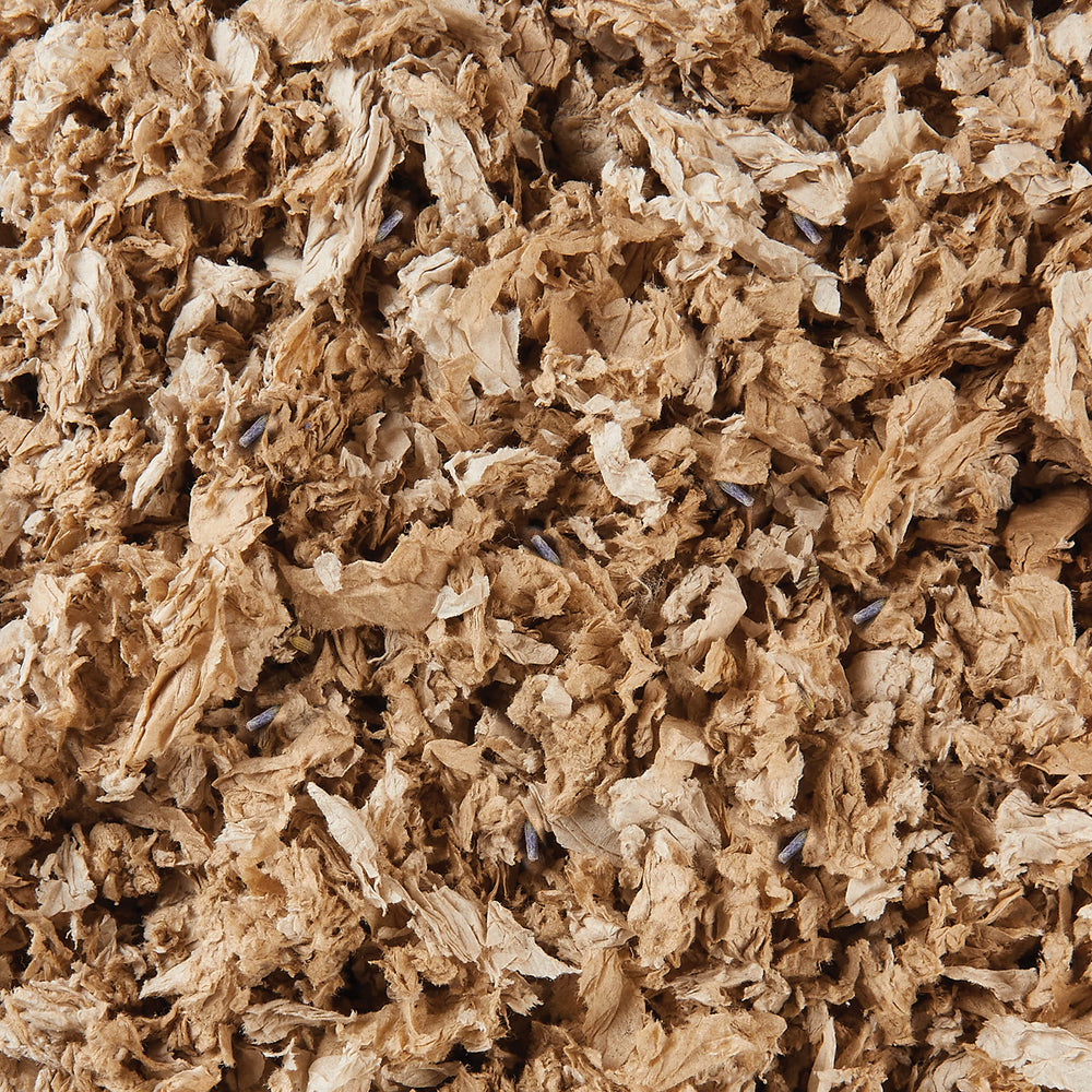 Kaytee bedding close-up shows absorption capability and soft texture for cozy nesting.