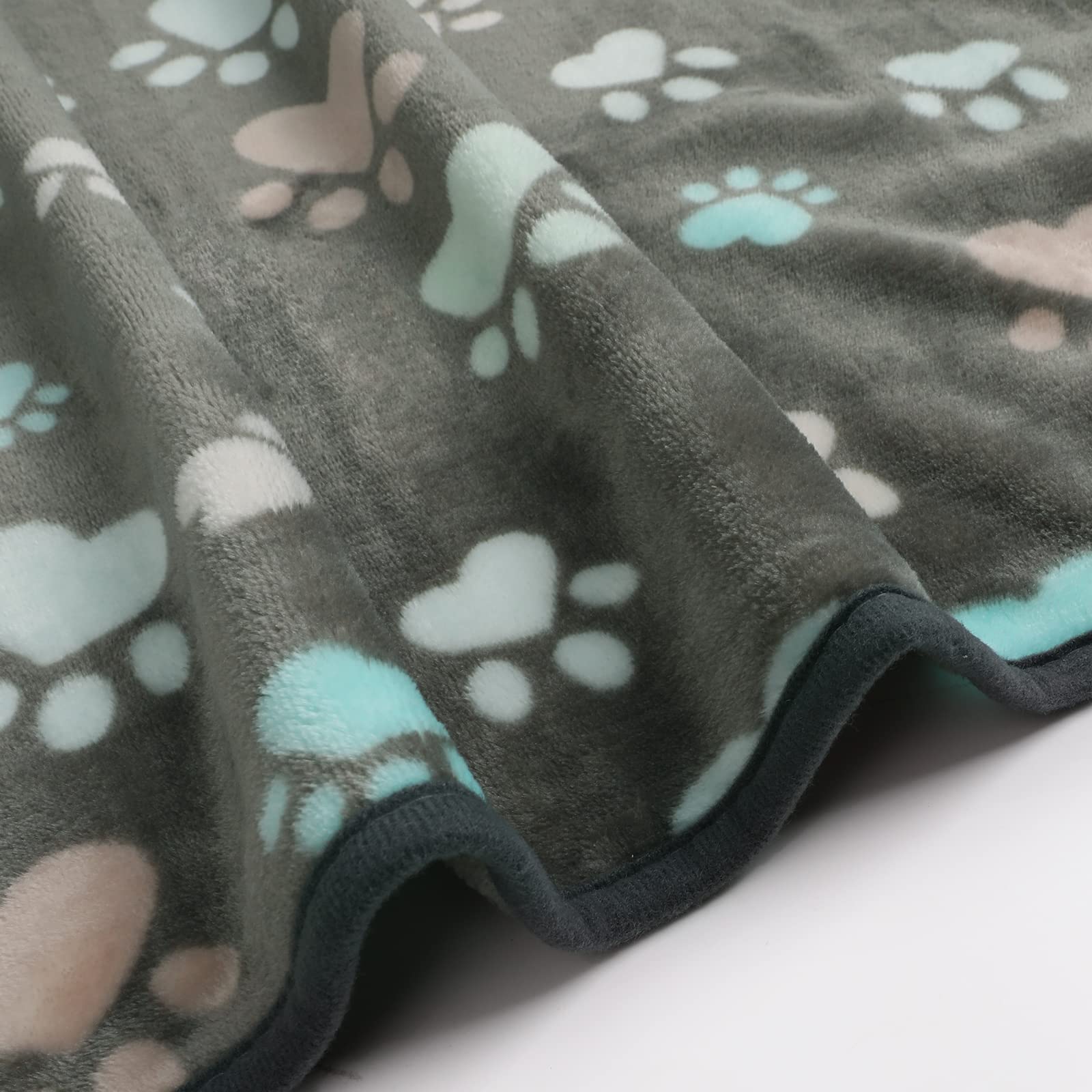 Luciphia blanket layered on pet bed, cozy warmth for lounging.