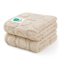 Luciphia small dog blanket on sofa protecting furniture with plush beige fleece.
