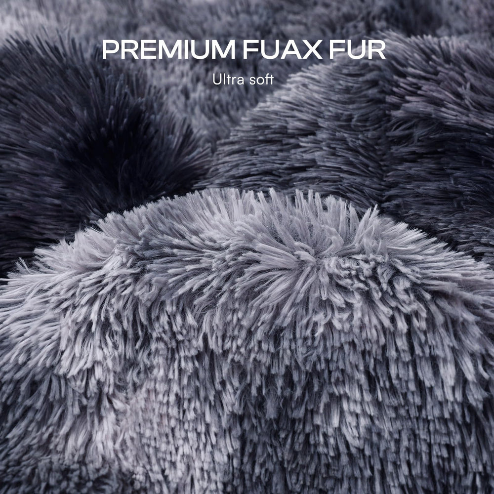 Luciphia tie-dye grey blanket draped over a bed for stylish decor.