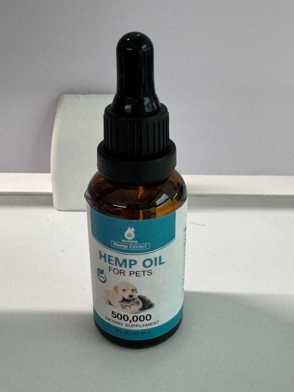 MaxHemp pet oil drops application on fur demonstrates easy dosing and care.