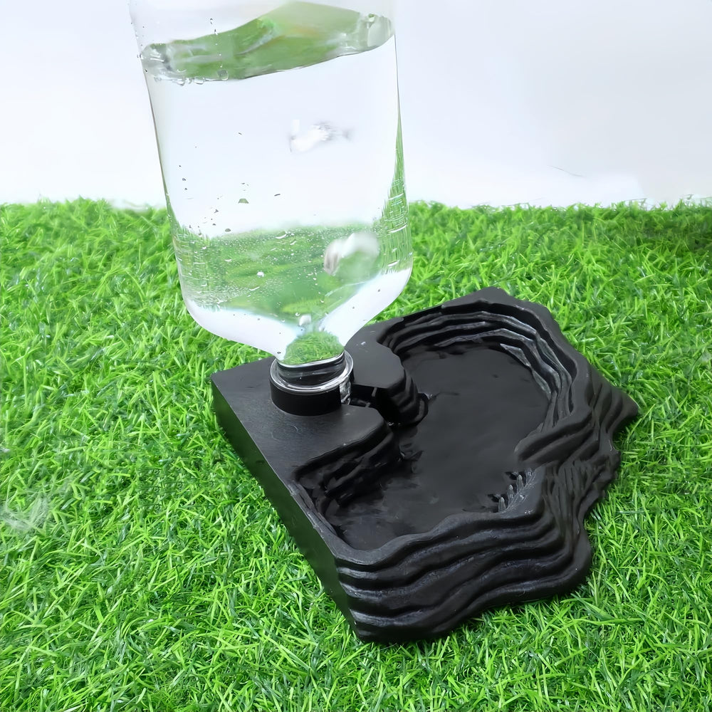 MRTIOO automatic dispenser attached to terrarium bottle for hands-free hydration.