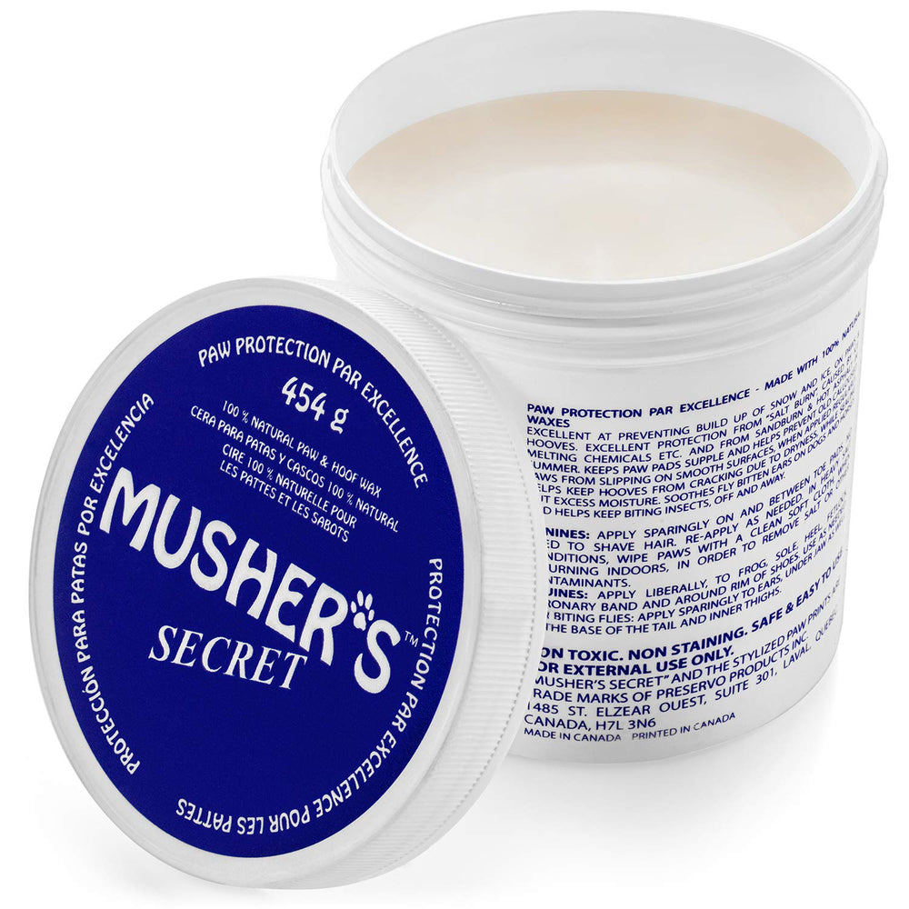 Musher's Secret paw wax tin close-up showing natural ingredients for paw protection.