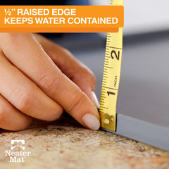 Neater Mat raised edge 1/2 inch contains spills effectively.