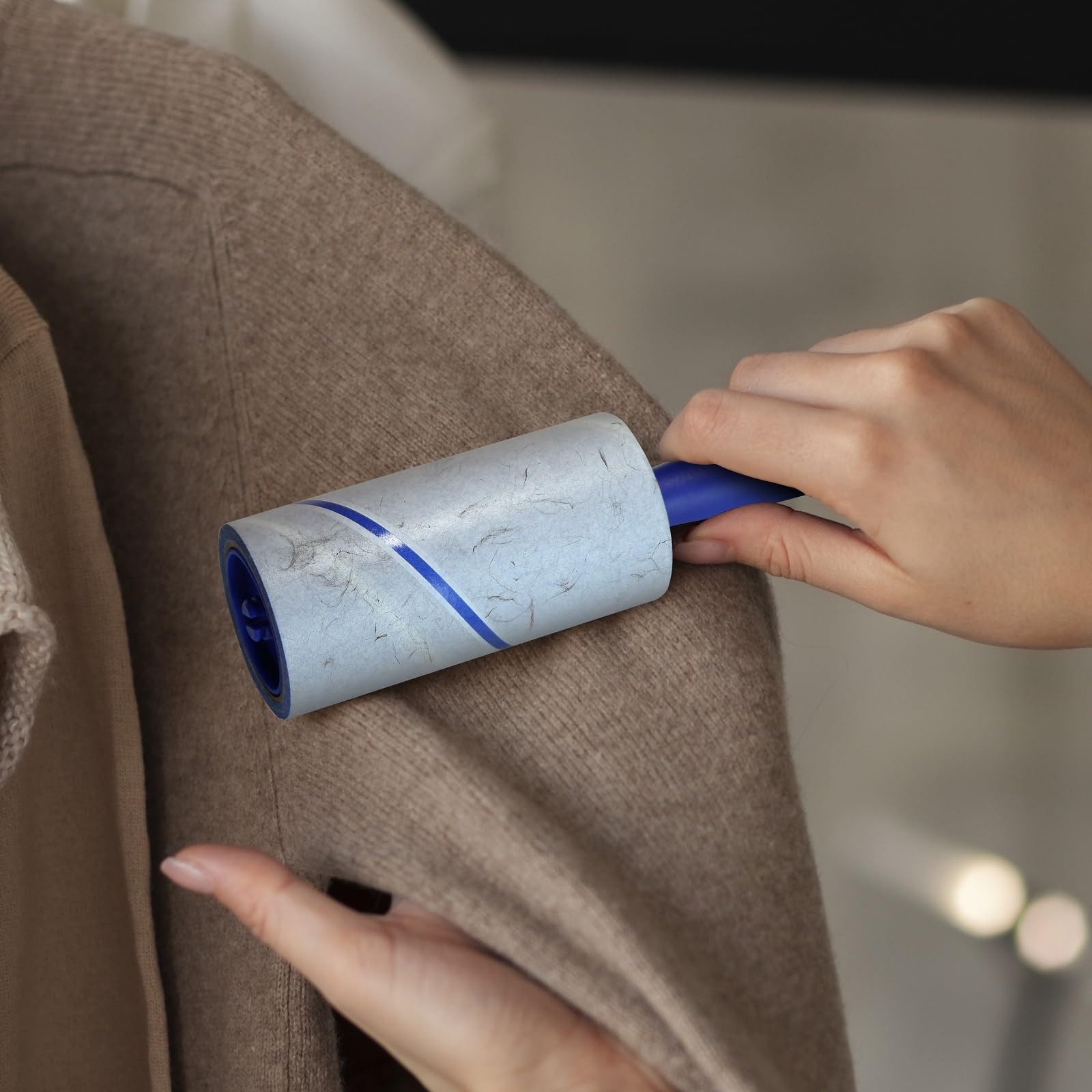 New England Stories lint roller on sofa refreshing upholstery