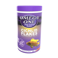 Omega One Cichlid Flakes bottle label shows quality ingredients for balanced diet.