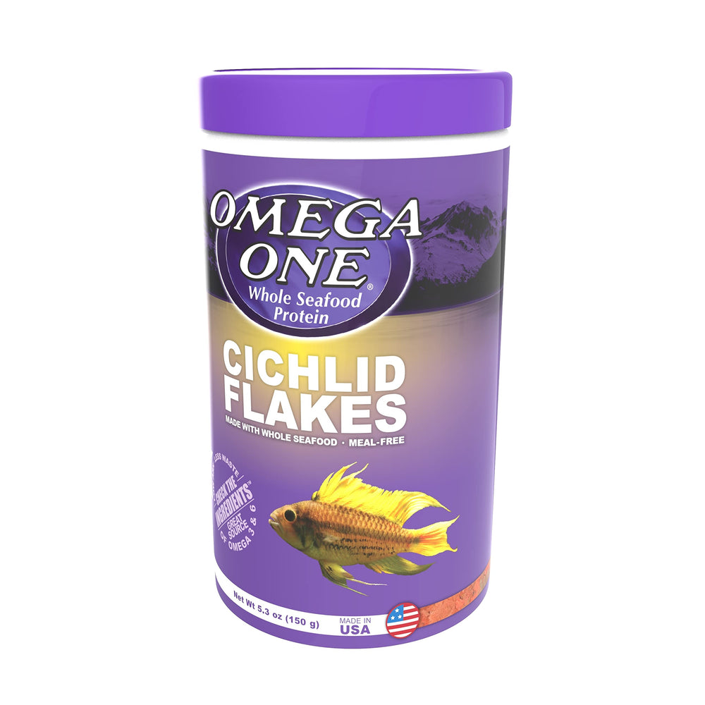 Omega One Cichlid Flakes being portioned into a feeding dish in aquarium.