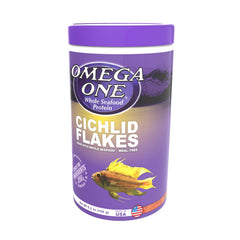 Omega One Cichlid Flakes being portioned into a feeding dish in aquarium.
