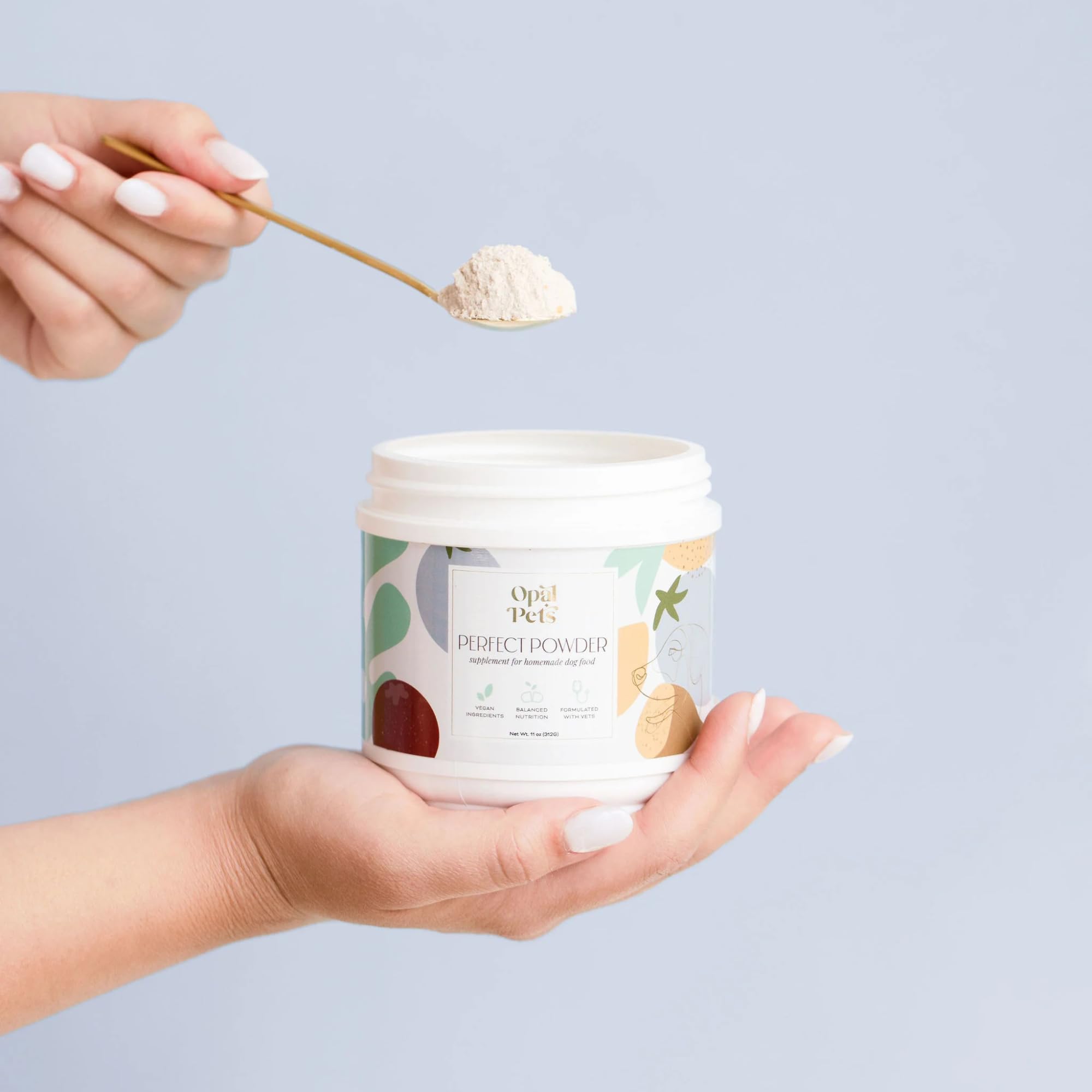 Opal Pets Perfect Powder being sprinkled into a bowl for a balanced meal.