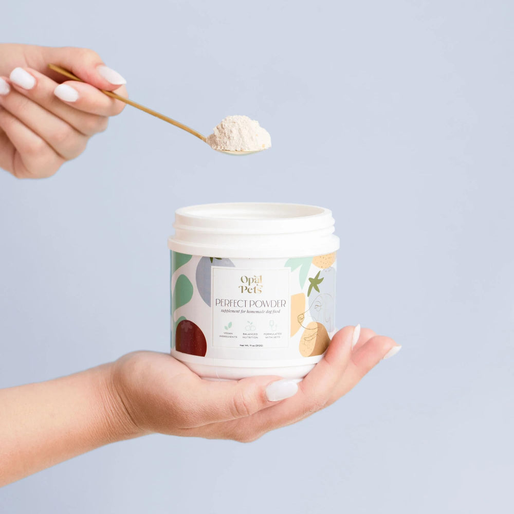 Opal Pets Perfect Powder being sprinkled into a bowl for a balanced meal.