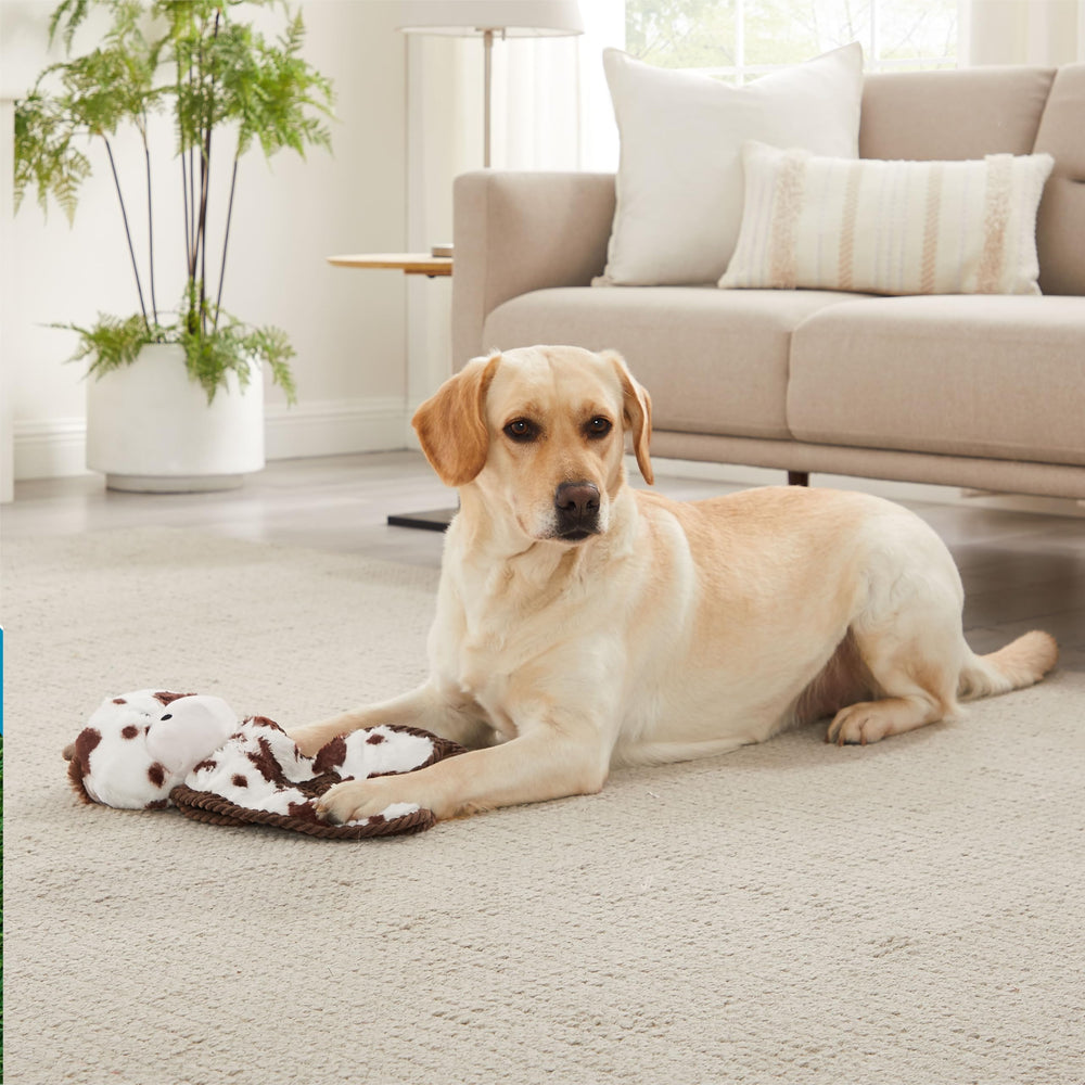 Outward Hound Cuddle Tugs cow plush body squeaker enhances tug-of-war fun.