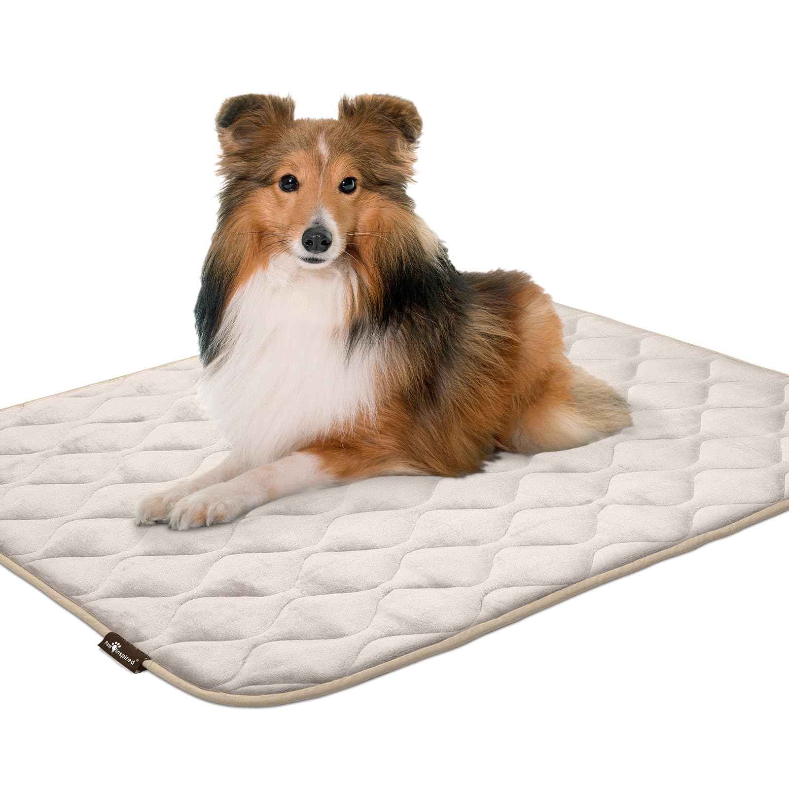 Paw Inspired plush crate pad shown in a kennel promotes calm rest