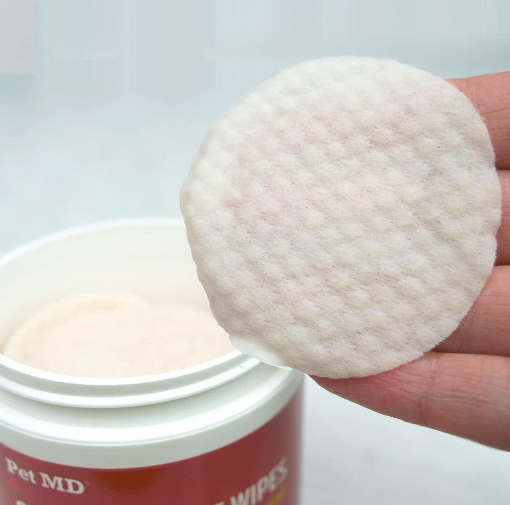 Pet MD topical wipes used between folds and skin for clean grooming.