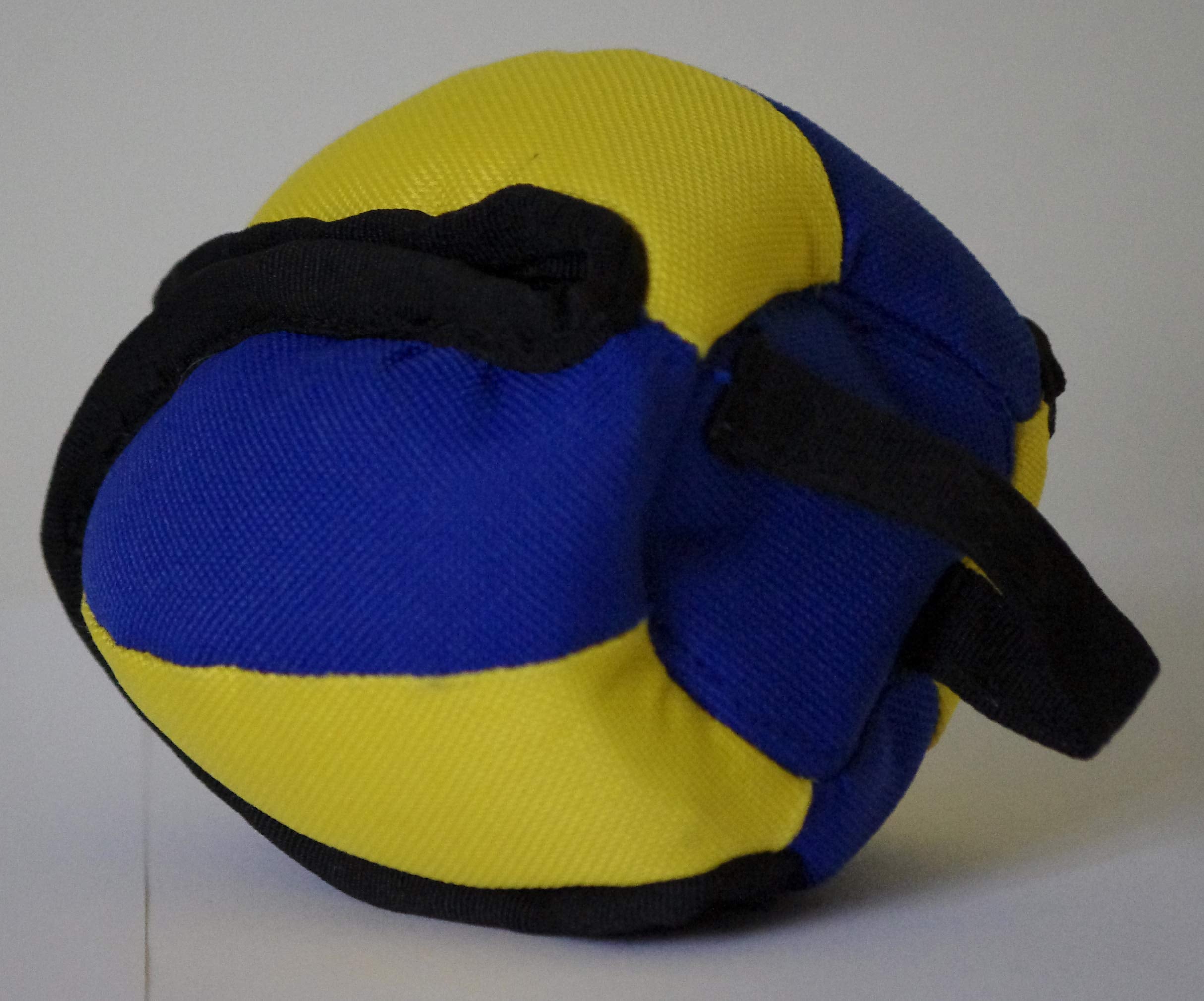 Positive Dogs Lo Ball Treat Pod Medium, dog playing with the bottom loop for fetch.