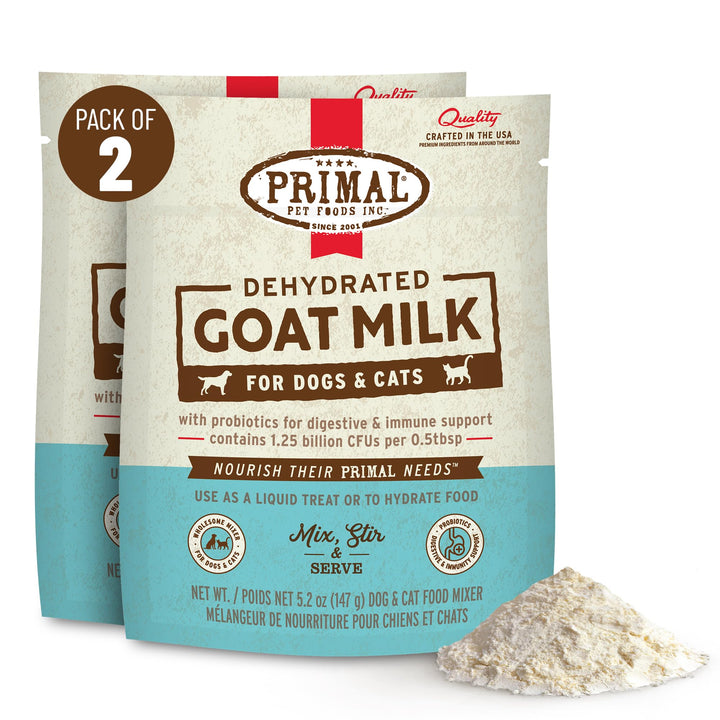 Primal Goat Milk Powder topper being stirred in warm water for hydration.