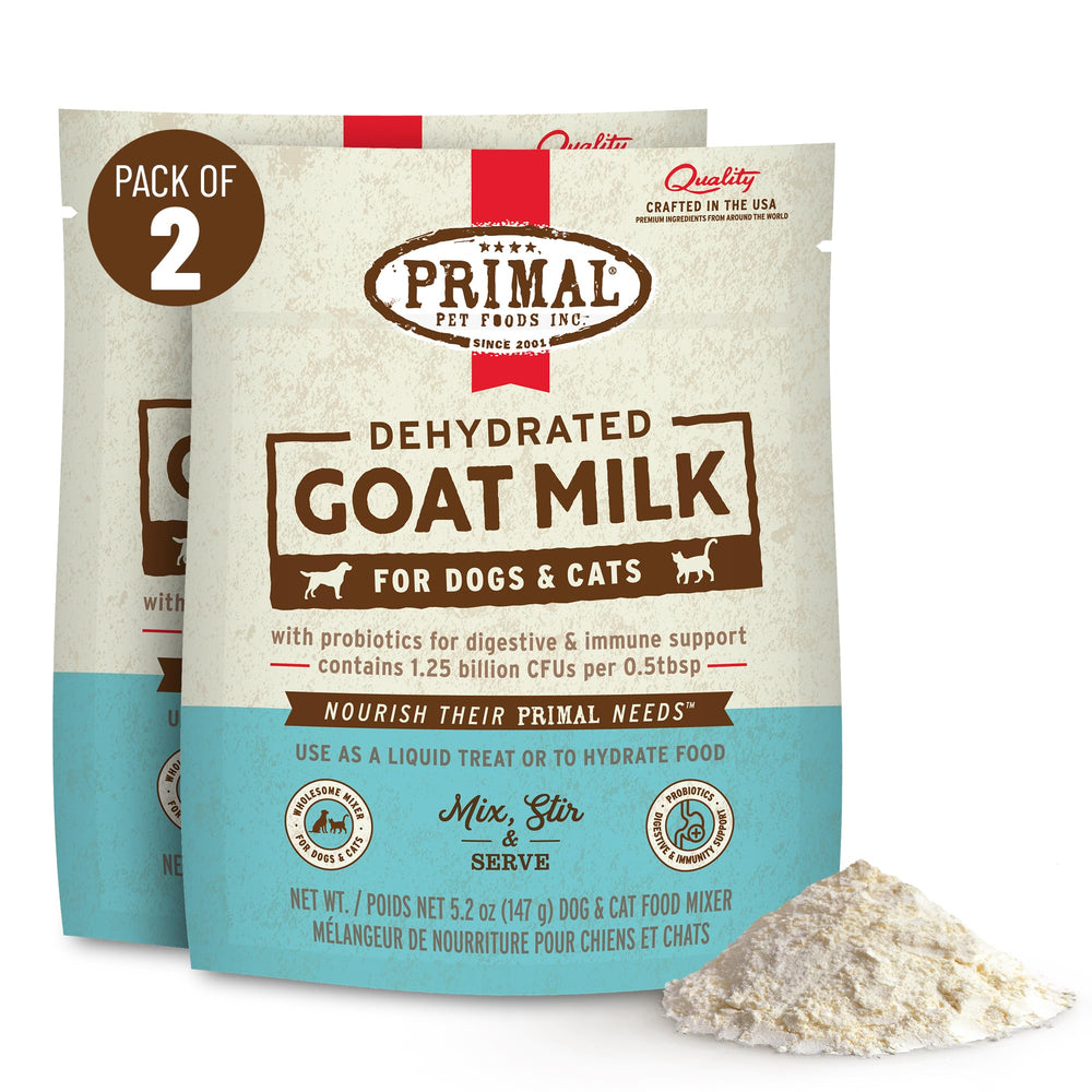 Primal Goat Milk Powder topper being stirred in warm water for hydration.