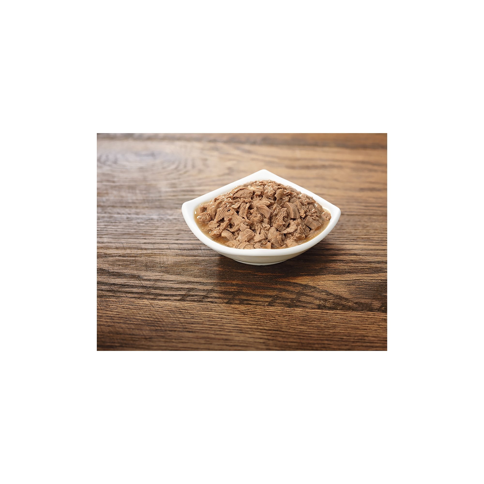 Purina Pro Plan Gravy Salmon Entree in Sauce served in bowl highlighting moist texture for meals.