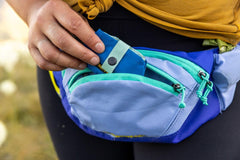 Ruffwear Trail Runner Bowl in blue pool color on the trail for visibility.