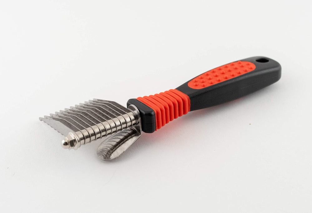 Close-up of the comfort grip on the Paw Brothers dematting tool for extended grooming