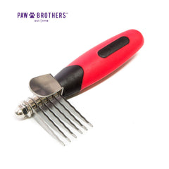 RYAN'S PET SUPPLIES Paw Brothers dematting tool in use during a dog grooming session.