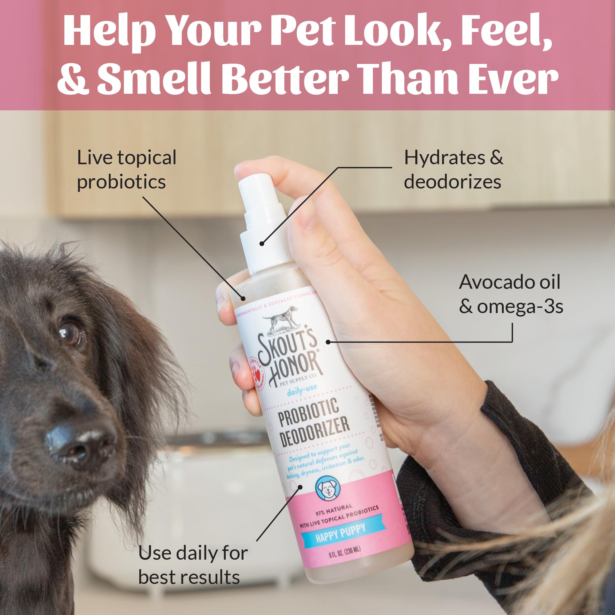 Spraying Skout's Honor probiotic deodorizer spray onto a pet coat