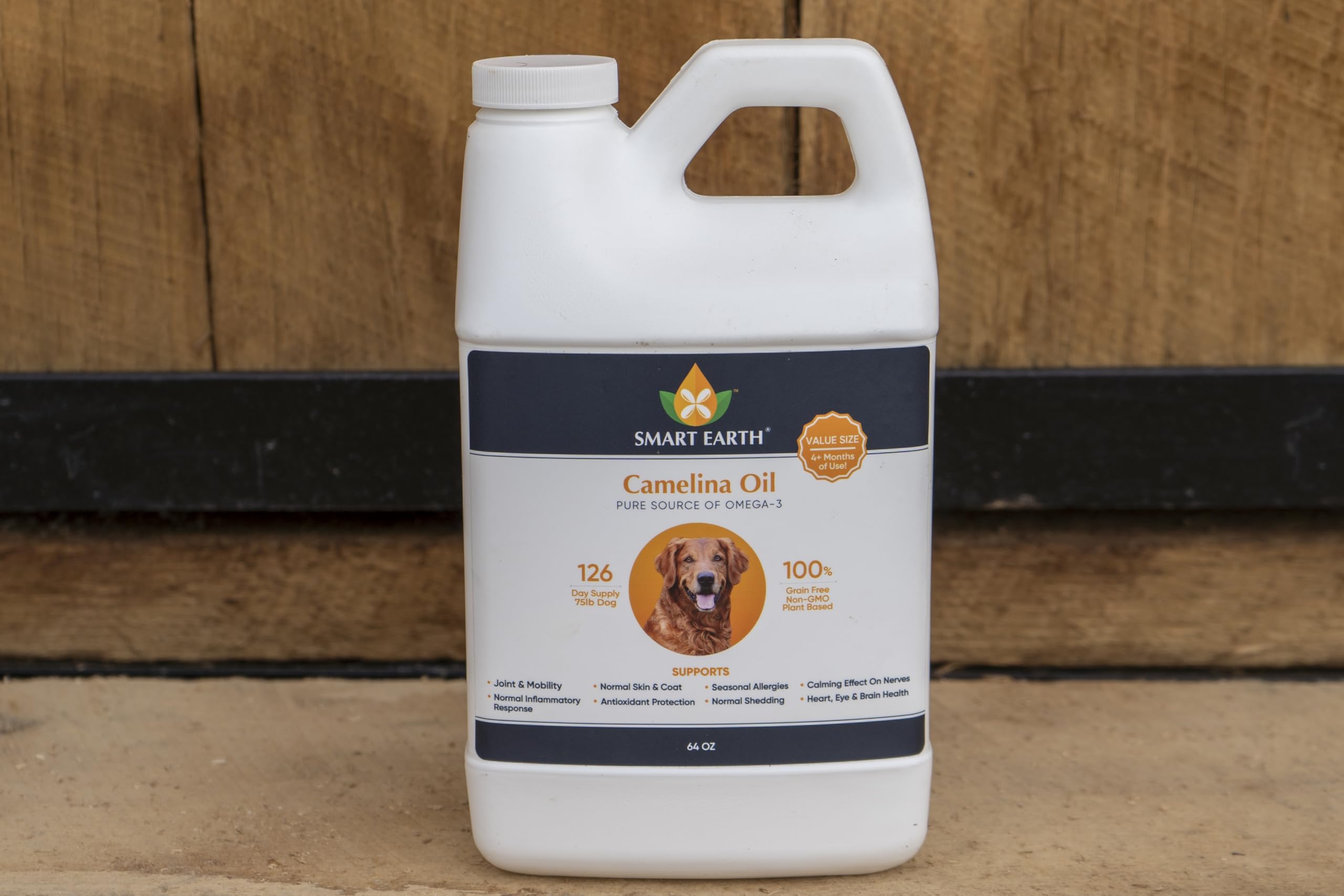 Smart Earth Camelina Oil for Dogs bottle with measuring spoon present.