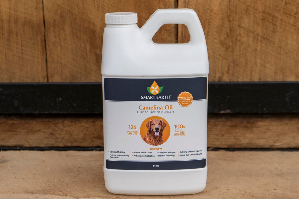 Smart Earth Camelina Oil for Dogs bottle with measuring spoon present.