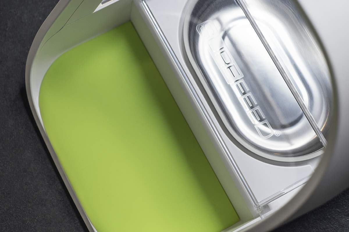 Close-up of SureFlap stainless steel bowls on a feeder, highlighting sealed design for fresher meals.