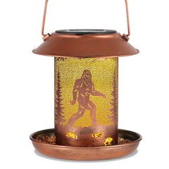Tepaken bird feeder sasquatch lantern on the ground invites birds and adds whimsical garden charm.