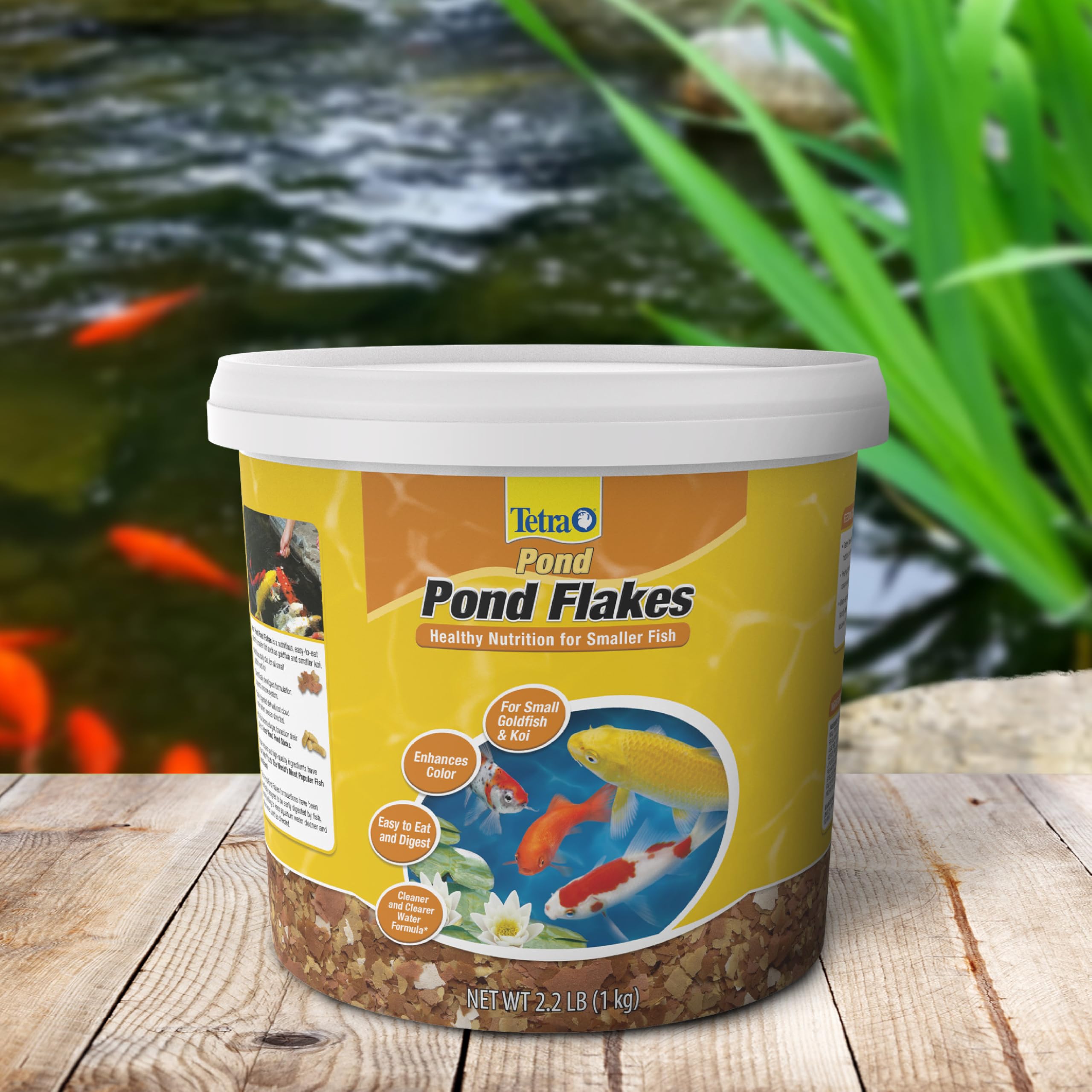 Tetra Pond Flakes packaging image highlights ready-to-feed flakes.